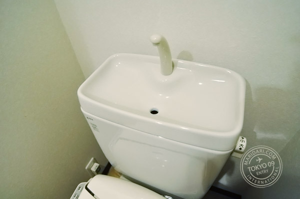 Washlet toilet unit with bidet and attached sink - water from sink is recycled for flushing